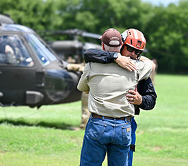Two men embrace at flood zone in Kerr County TX