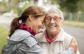 Older woman and younger woman embracing
