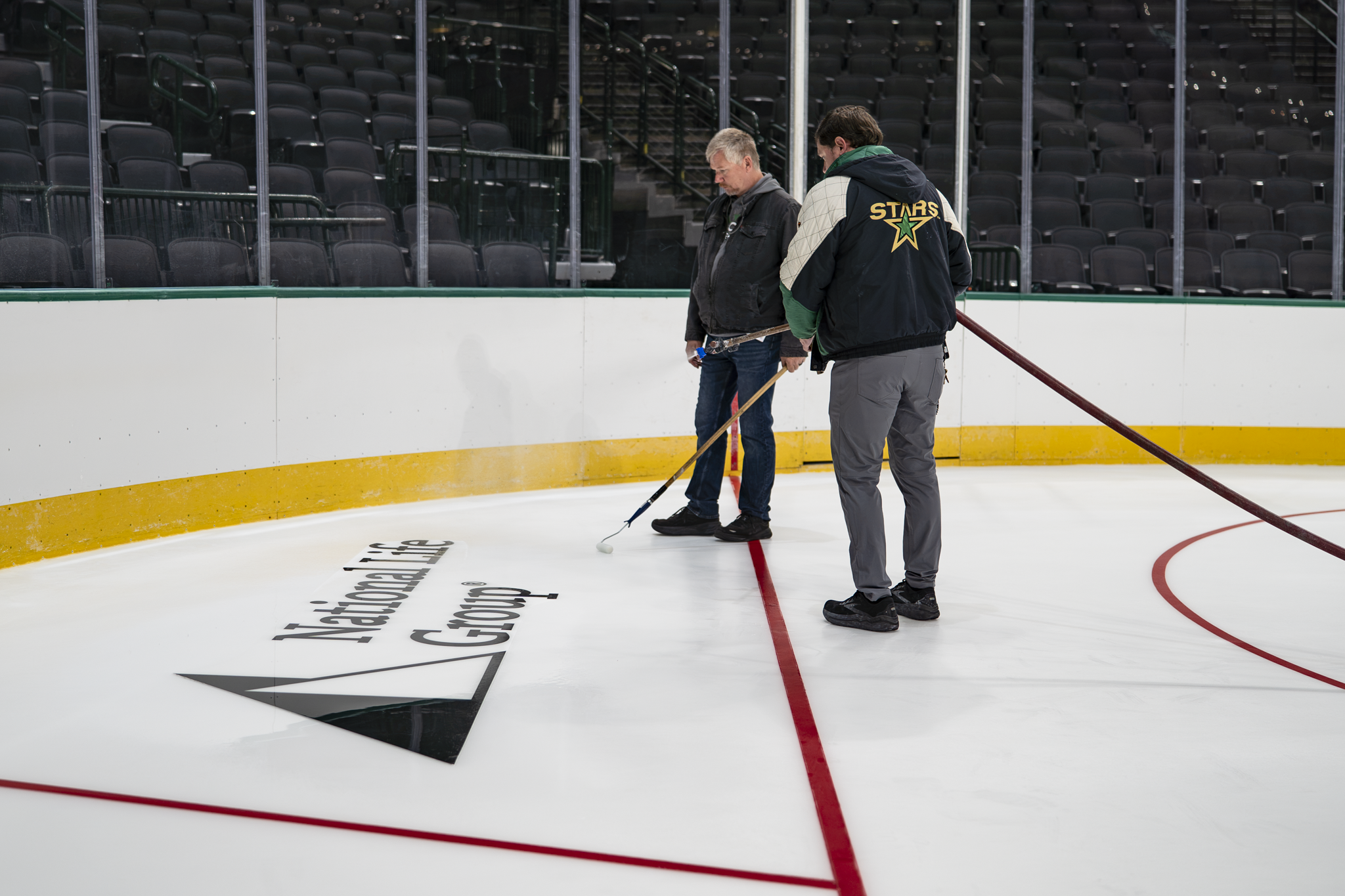 National Life Group logo being installed on the Dallas Stars hockey rink ice