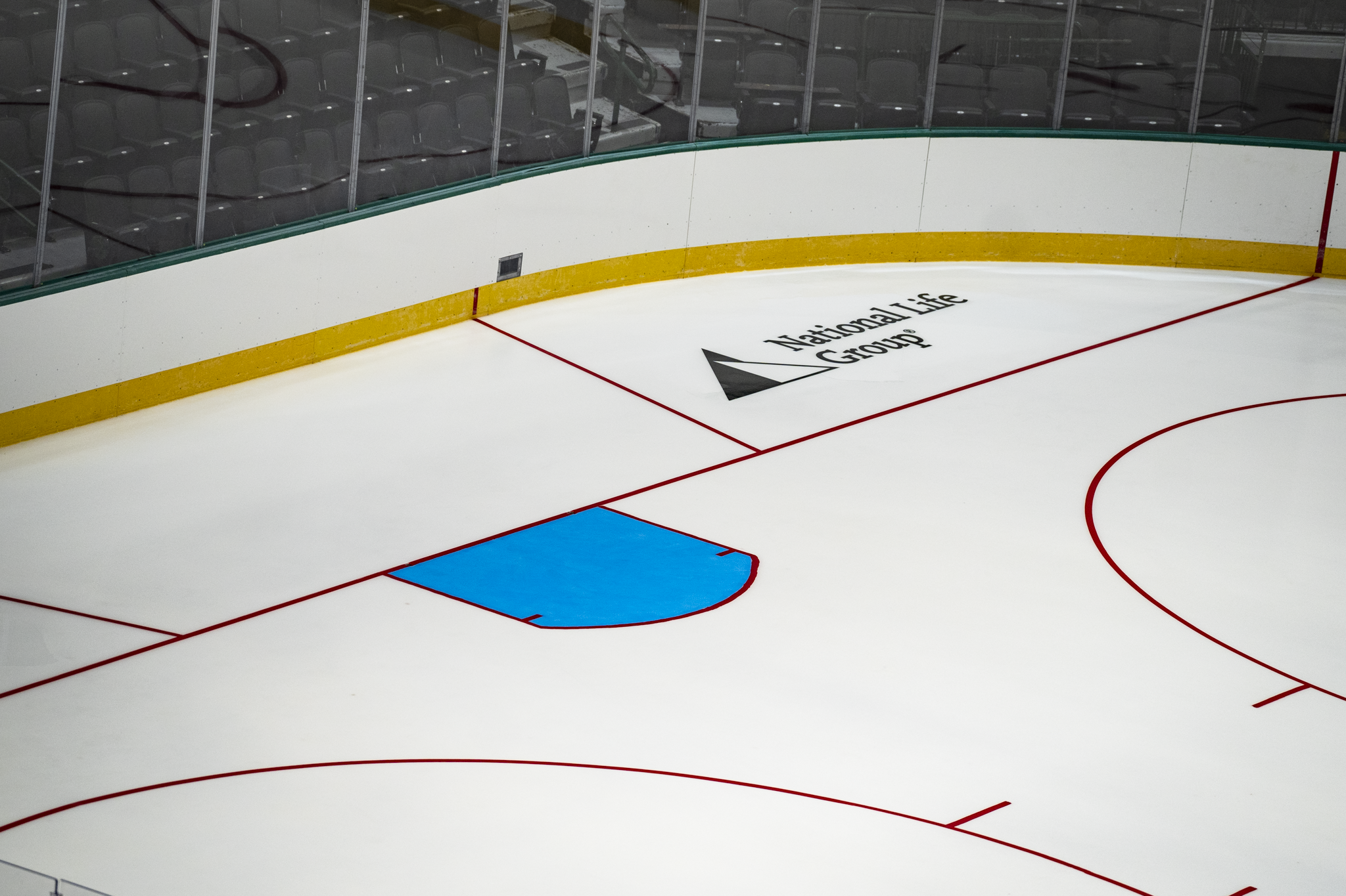 Wide view of the Dallas Stars hockey rink with the National Life Group logo displayed on the ice