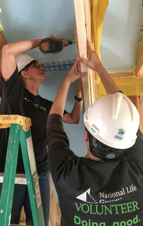 Employee volunteers spend a day working with Habitat for Humanity.